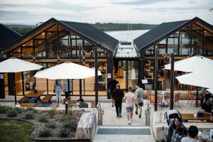 a building with people walking in front of it at Huskisson Hotel in Huskisson