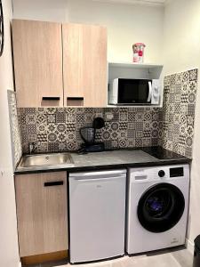 a kitchen with a washing machine and a microwave at Luxury Dreams Balneo in Le Cannet +4 photos
