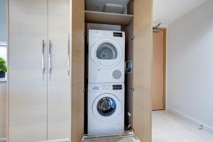 a laundry room with a washer and dryer at Downtown Properties in Vancouver