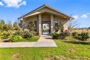 a small house with a pathway leading to the front door at Quality Hotel Point Cook in Point Cook