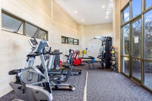 a gym with several treadmills and elliptical machines at Quality Hotel Point Cook in Point Cook
