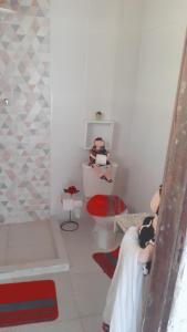 a white bathroom with a tub and a toilet at Fazenda Águas Claras in Mendes