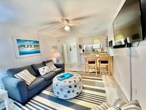 a living room with a couch and a table at Lovely 2 bedroom condo with ocean view 304 in Myrtle Beach