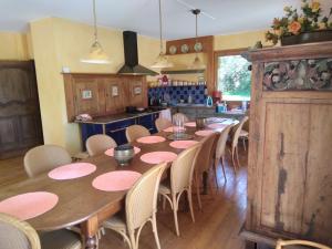 a dining room with a long table and chairs at LES DAMES DE LA SAUGIAT in Le Fied