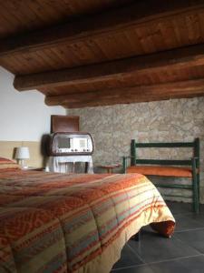 a bedroom with a bed and a tv in it at Bed & Breakfast Hostel H24 in Ragusa