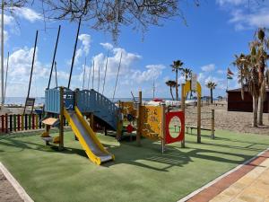a group of playground equipment on a beach at Mijas Playa Retreat in La Cala de Mijas