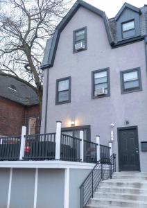 a large house with a staircase in front of it at Art Deco Graffiti Suite in Philadelphia