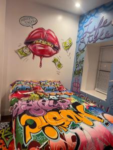a bedroom with a bed with a mouth on the wall at Art Deco Graffiti Suite in Philadelphia