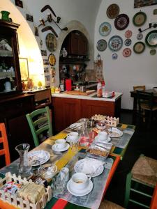 a table with food and plates on it in a kitchen at Bed & Breakfast Hostel H24 in Ragusa