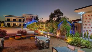 a patio with tables and plants in a courtyard at Wixky hotel in Nong Khai