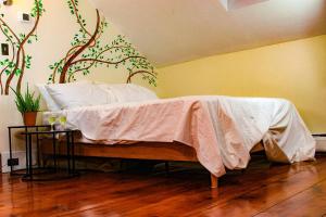 - une chambre avec un lit orné d'une fresque murale sur les arbres dans l'établissement Long Mountain Suite, à Amherst