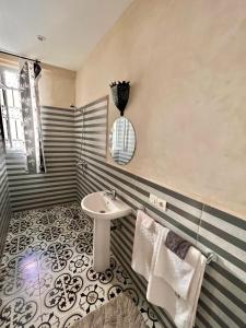 a bathroom with a sink and a mirror at Riad Allal in Marrakesh