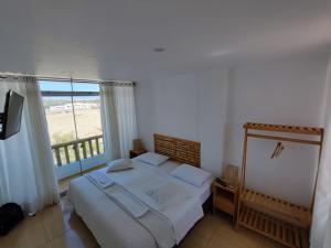 a bedroom with a bed and a large window at Paracas Guest House in Paracas +30 photos