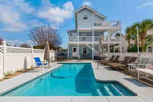 a house with a swimming pool in front of a house at Beach House of Stress Relief in Destin