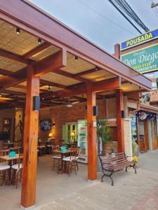 a restaurant with tables and chairs in front of it at Pousada Don Diego in Ubatuba