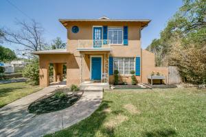 a house with a blue door and a yard at Historical Home in Iconic Alamo Heights - Sky view in San Antonio