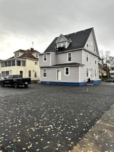 a large house with a truck parked in a parking lot at Newly 5 Star 3 Beds 1 Bath ideal Short term rental in Schenectady