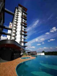 a large building with a swimming pool in front of it at Hanns&FreeWiFi&Washer&Parking &Pool&Sauna&Sunshine Comfort Homstay2 in Sibu