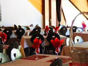 a room filled with tables and chairs with red bows at Res Le Parc des Vosges du Nord, Bitche, holiday home for 5 pers in Bitche