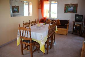 a dining room with a table and chairs and a couch at Akrojali in Kómpoi