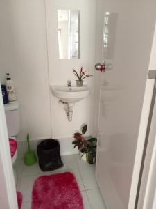 a bathroom with a sink and a shower with a mirror at Phirst Park Homes Townhouse in Lipa