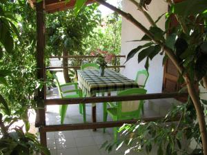 a table and chairs on a balcony with trees at Nikos 5 in Kakovatos