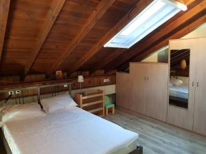 a bedroom with a large white bed and a skylight at Iliana in Skotína +44 photos