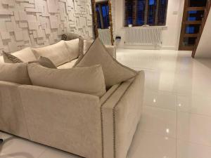 a white couch sitting in a living room at Modern home in quiet neighbourly street, perfect for Work From Home, quick links to centre in Manchester