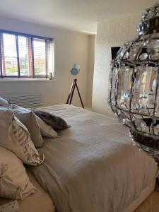 a bedroom with a bed with a chandelier at Modern home in quiet neighbourly street, perfect for Work From Home, quick links to centre in Manchester