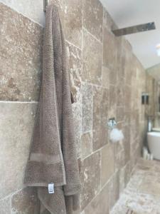 a towel hanging on a wall in a bathroom at Modern home in quiet neighbourly street, perfect for Work From Home, quick links to centre in Manchester