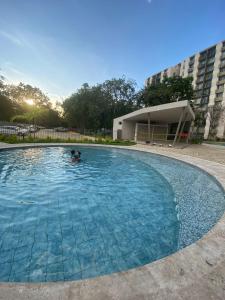 a person swimming in a large swimming pool at Vacations in Playa Dormida