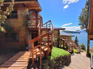 una casa con una escalera de madera que conduce a una terraza en Destinar Apartments, en San Carlos de Bariloche