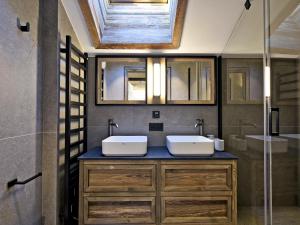 a bathroom with two sinks and a glass shower at Penthouse Luxueux à Méribel avec SPA et Services Inclus - FR-1-613-32 in Méribel +25 photos