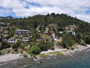 an aerial view of a town on a hill next to the water at Destinar Apartments in San Carlos de Bariloche