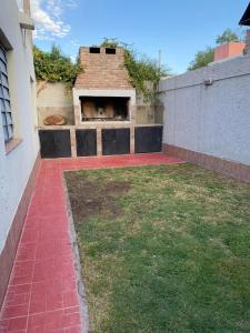 a backyard with a brick oven in a building at Casa Balcarce Mendoza in Guaymallen