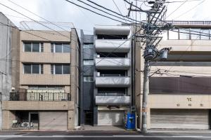 an apartment building with balconies on the side of a street at trive osu kannon 駅チカ 大須商店街スグ 大須観音駅 徒歩30秒の好立地 in Minami-sotoborichō