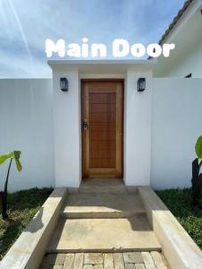 a main door of a white building with a sign on it at Allure Villa Cempaka Private Pool in Kuantan