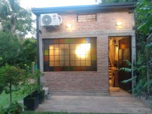 a small house with a window and a fan at Loft El Taller - Rústico, elegante, acogedor in Yerba Buena