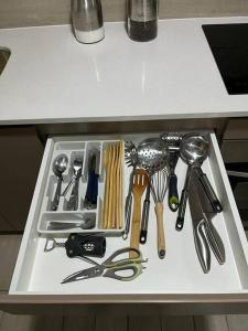 a drawer full of kitchen utensils on a counter at Depto nuevo en Santiago in Santiago