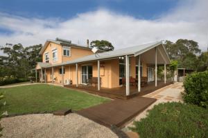 a house with a deck and a yard at Mhara Downs Country Escape in Foster