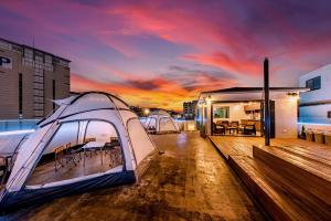 a tent on the deck of a building with a sunset at The Jade Hotel in Jeju