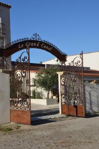 a gate leading to a building with a fence at Le Grand Canal in Martigues