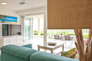 a living room with a blue couch and a table at Crest Premium View Apartment 19 in Noosa Heads