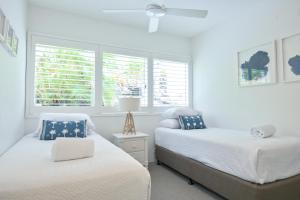 a bedroom with two beds and a window at Crest Premium View Apartment 19 in Noosa Heads