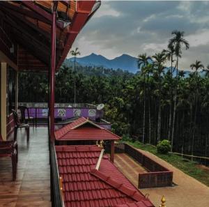 a balcony of a house with a view of the mountains at River Edge-Kudremukha in Kalasa