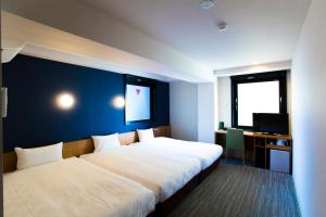 Postel nebo postele na pokoji v ubytování Hotel Meldia Kyotoshijoomiya