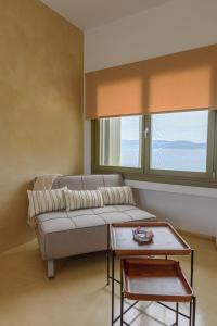 a living room with a couch and a table at Agrielia Seafront Katigiorgis, Agios Georgios, Pelion in Agios Georgios +69 photos