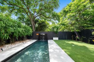 a swimming pool in the backyard of a house at Fairfield Palace in Brisbane