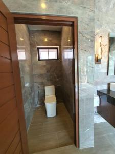 a bathroom with a toilet and a walk in shower at Siri Thai Lodges in Hua Hin