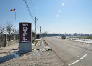 a sign for a motel on the side of a road at Motel Alexander in Olteniţa